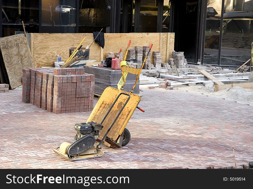 A machine used for leveling bricks in a new courtyard. A machine used for leveling bricks in a new courtyard