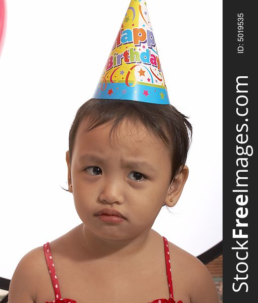 Unhappy Child With Party Hat