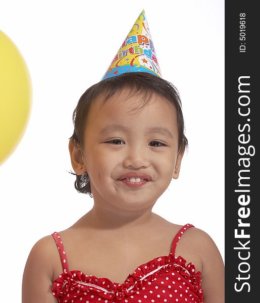 Girl with party hat on red top