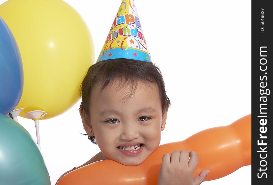 Happy child with party hat and colorful balloons