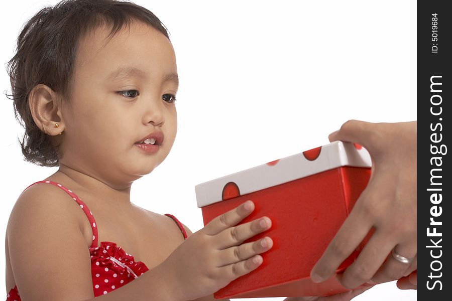 Little young girl holding a red gift box