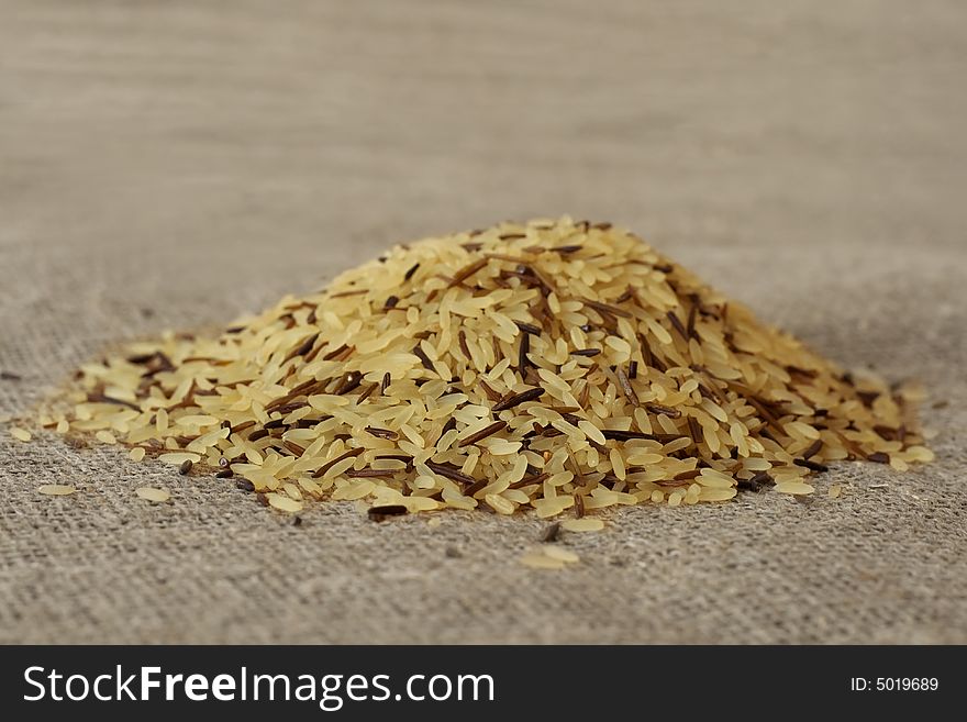 Wild rice grains, close-up, on a textile background