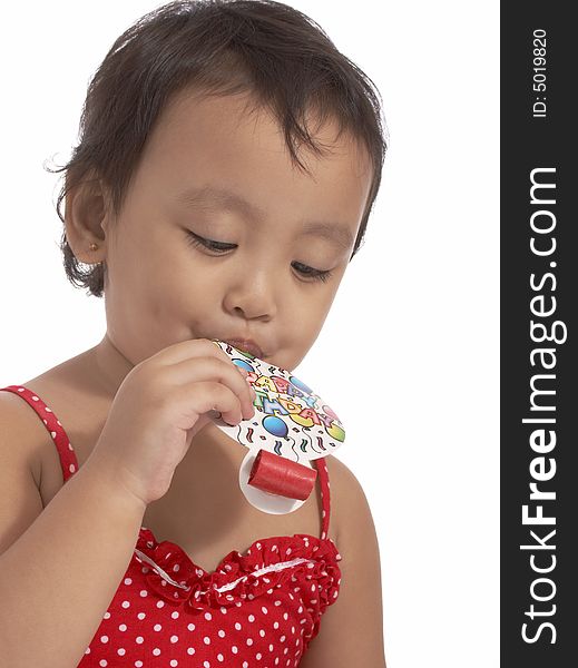 Attractive little girl holding a party popper
