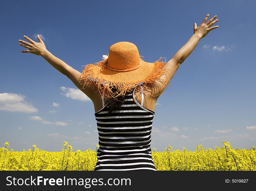 Teenagers in the rape field stretched hands in the air