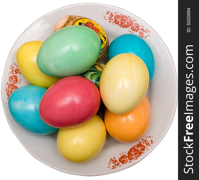 Colored easter eggs on the plate white isolated