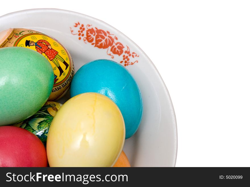 Colored easter eggs on the plate white isolated