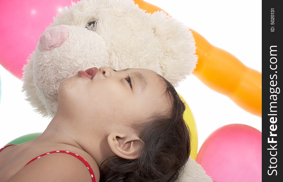 Child looking up with teddy bear on a white background