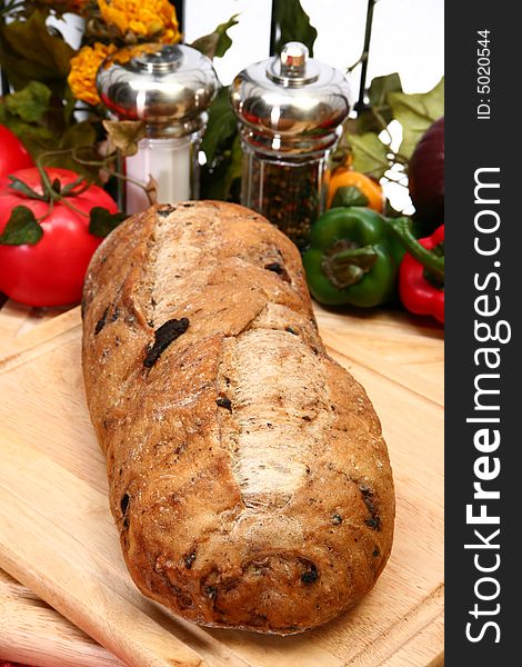 Whole olive bread loaf with parsley butter in kitchen or restaurant. Whole olive bread loaf with parsley butter in kitchen or restaurant.