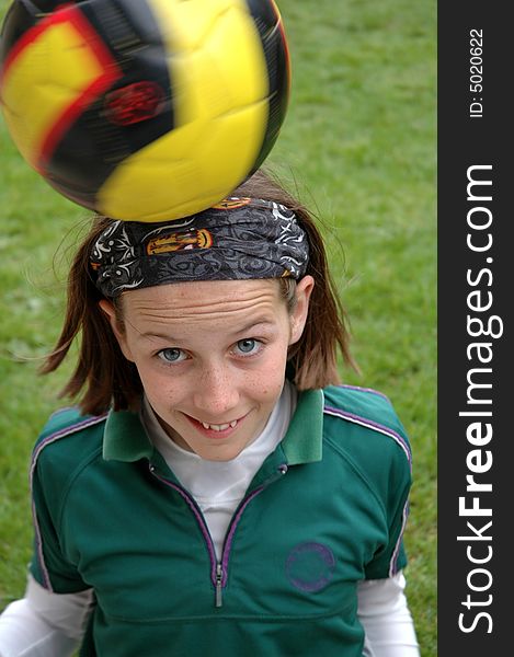 Close-up of child balancing ball on her head. Close-up of child balancing ball on her head