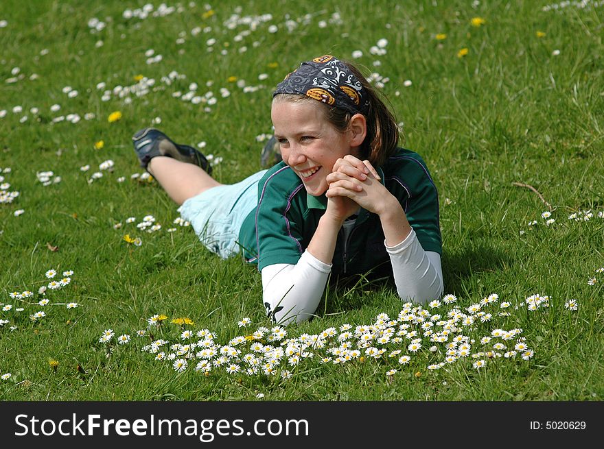 Child Lying In The Grass In Spring