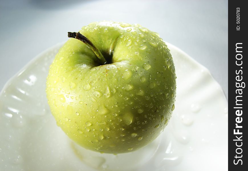 Fresh green apple with waterdrops on white background. Fresh green apple with waterdrops on white background