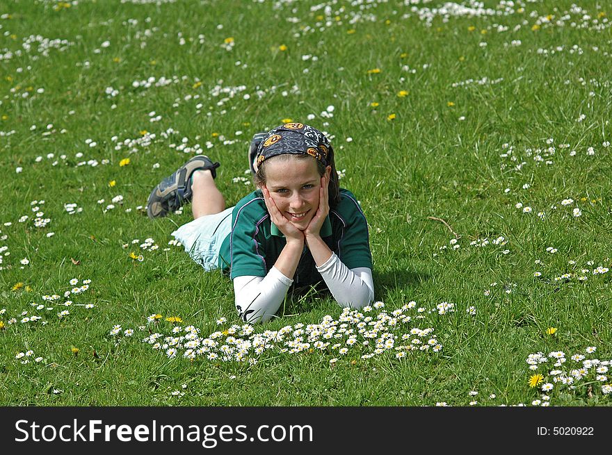 Young Girl Lying In Grass In Springtime