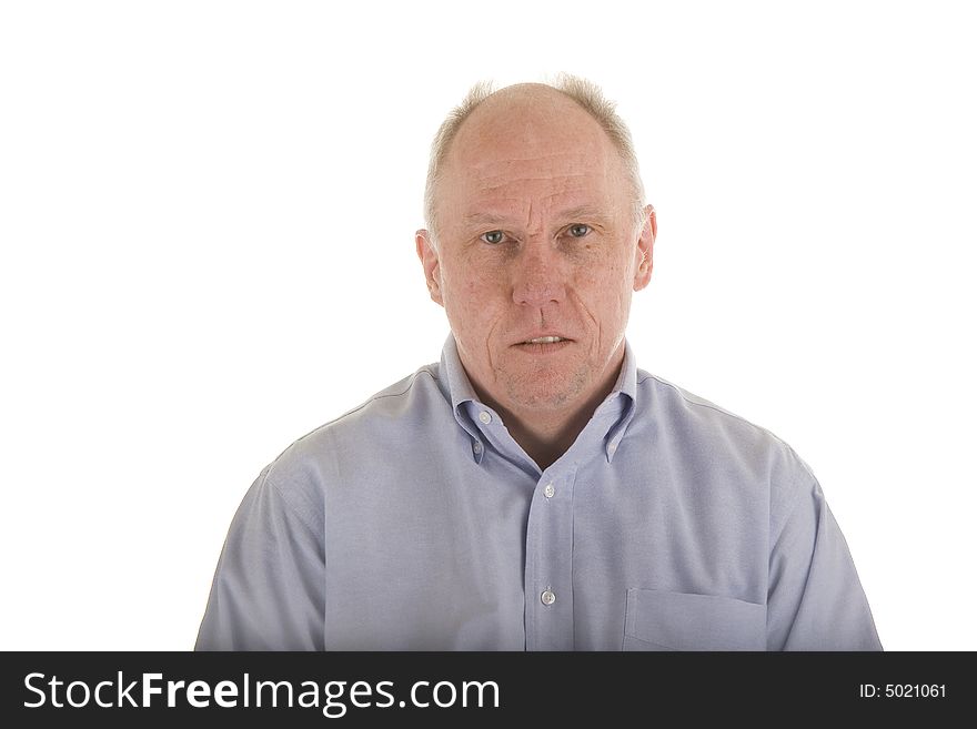 An older guy in a blue dress shirt looking serious. An older guy in a blue dress shirt looking serious