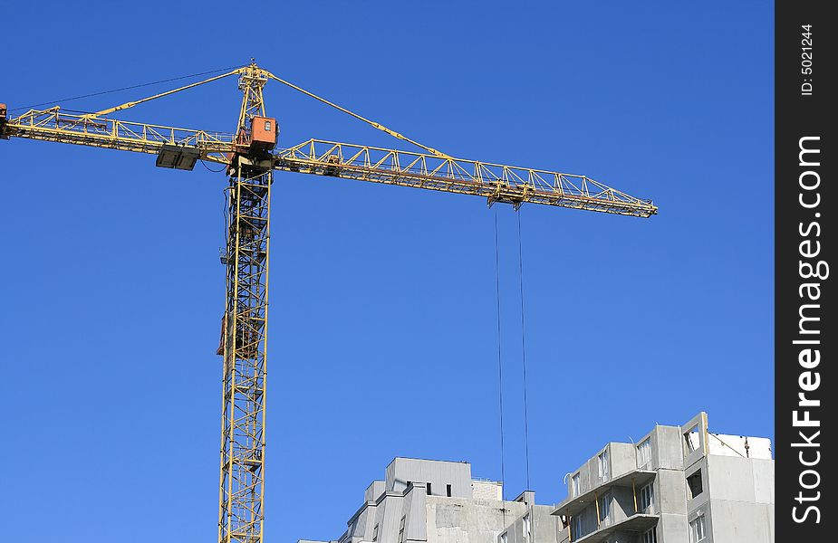 A under construction house on a background of the blue sky