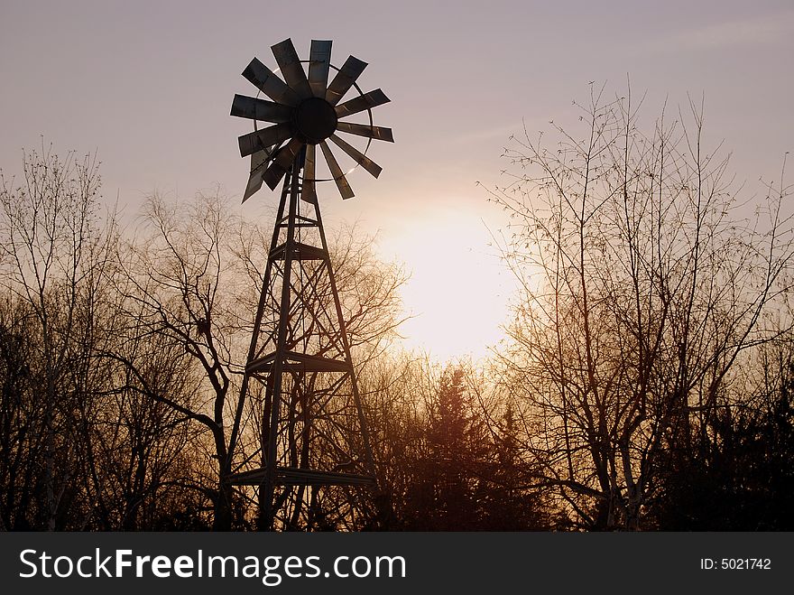A sunset behind a windmill