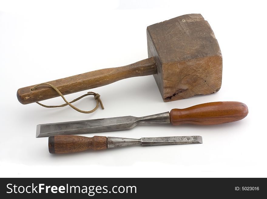 Antique wooden mallet and two vintage socket chisels isolated on a white background. Antique wooden mallet and two vintage socket chisels isolated on a white background