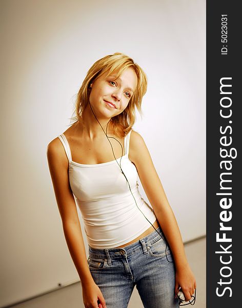 A young blonde girl listening to music