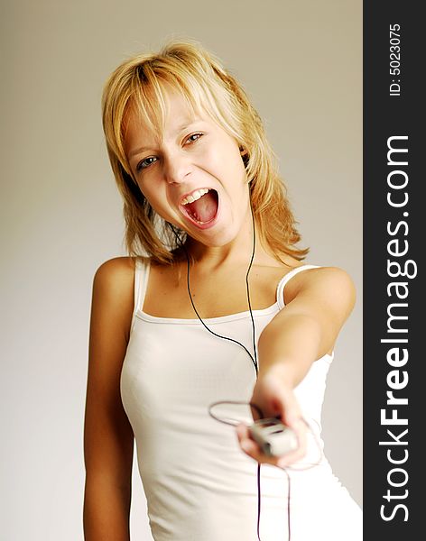 A young blonde girl listening to music