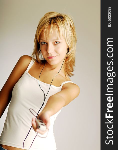 A young blonde girl listening to music