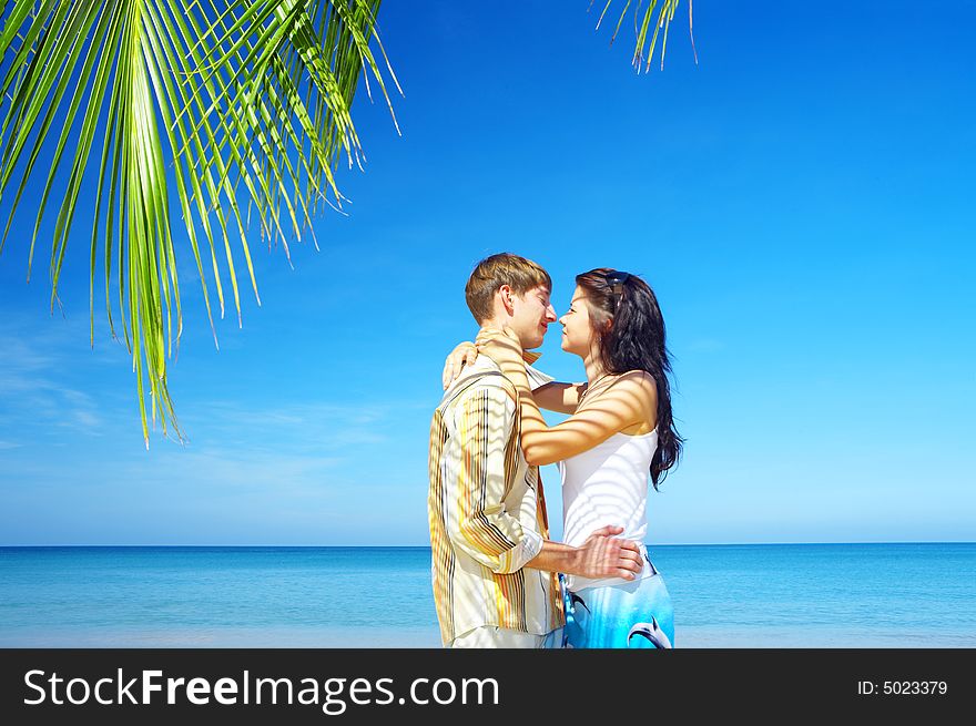 A portrait of attractive couple having date on the beach. A portrait of attractive couple having date on the beach