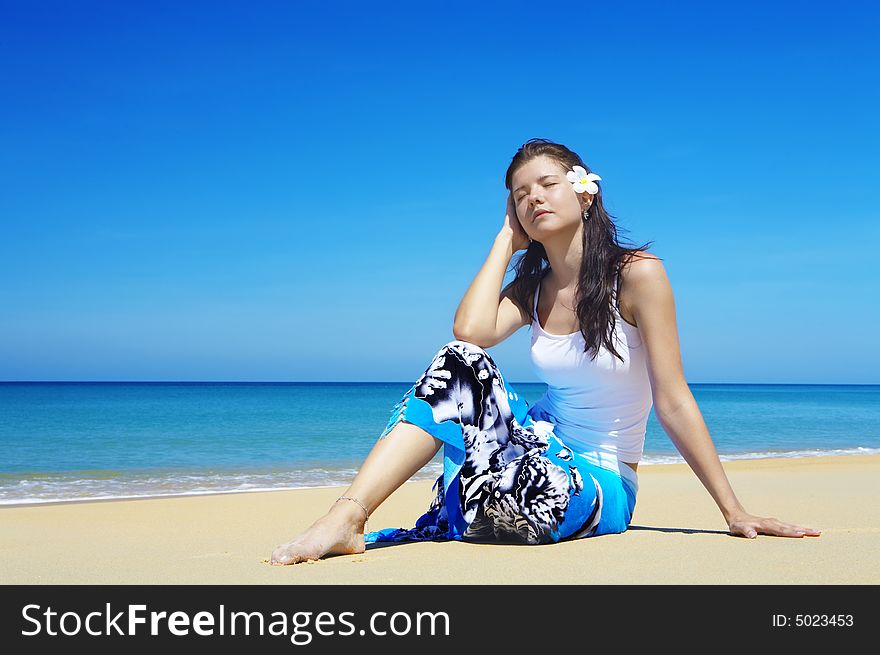View of nice young gorgeous female relaxing on beach. View of nice young gorgeous female relaxing on beach