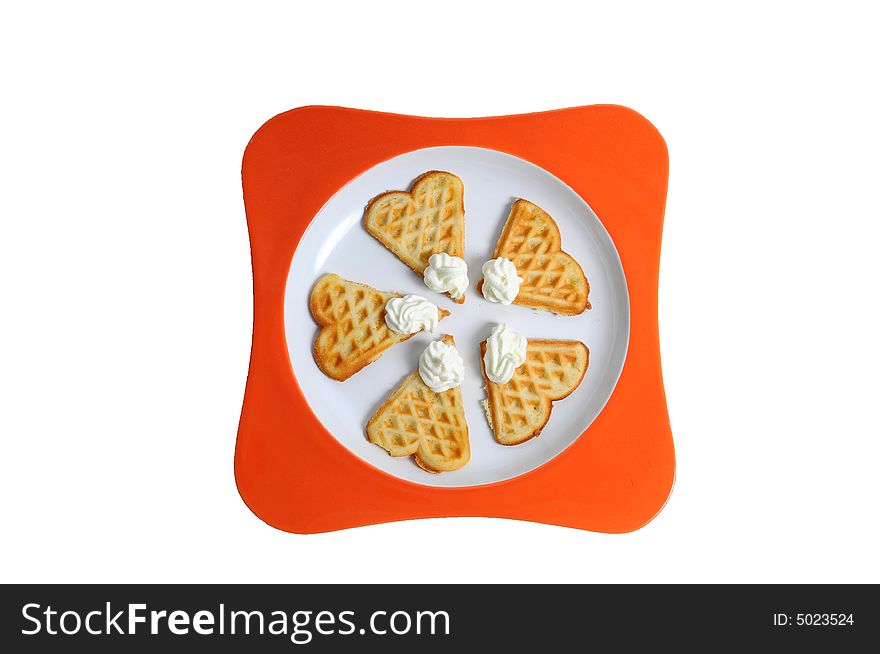 Tasty waffles with whipped cream on a plate. Tasty waffles with whipped cream on a plate