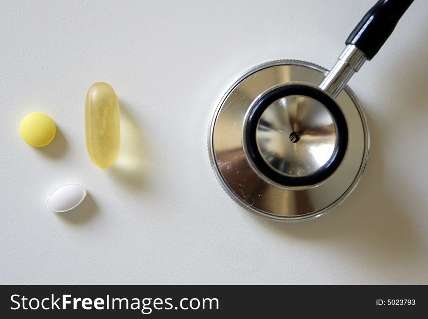 Stethoscope and pills - conceptual photo
