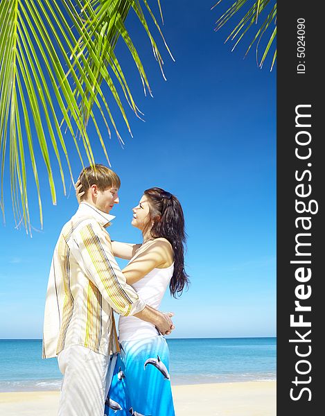 A portrait of attractive couple having date on the beach. A portrait of attractive couple having date on the beach