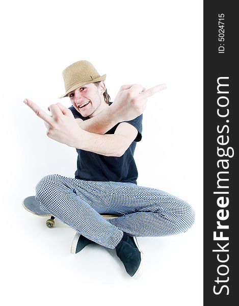 Emotional teenager sitting on skate isolated on white background. Emotional teenager sitting on skate isolated on white background