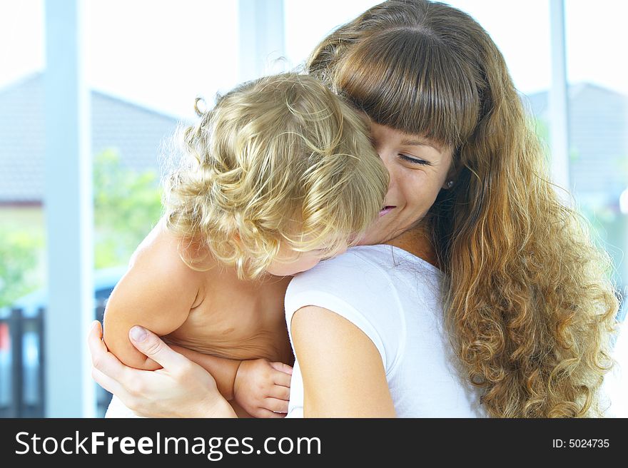 High key portrait of happy mother with baby. High key portrait of happy mother with baby