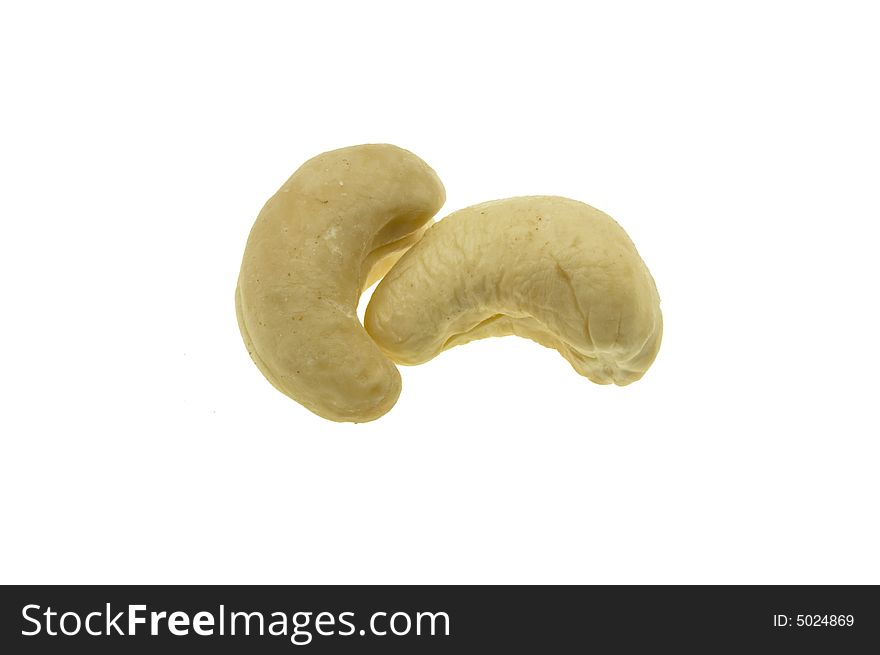 Two whole cashew nuts isolated against white background