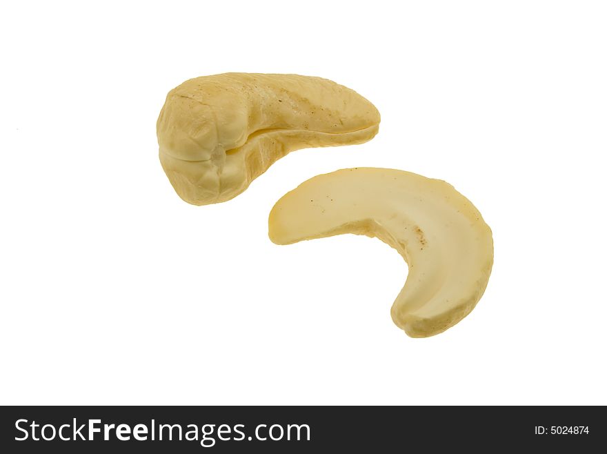 One whole and one half cashew nut isolated against white background. One whole and one half cashew nut isolated against white background