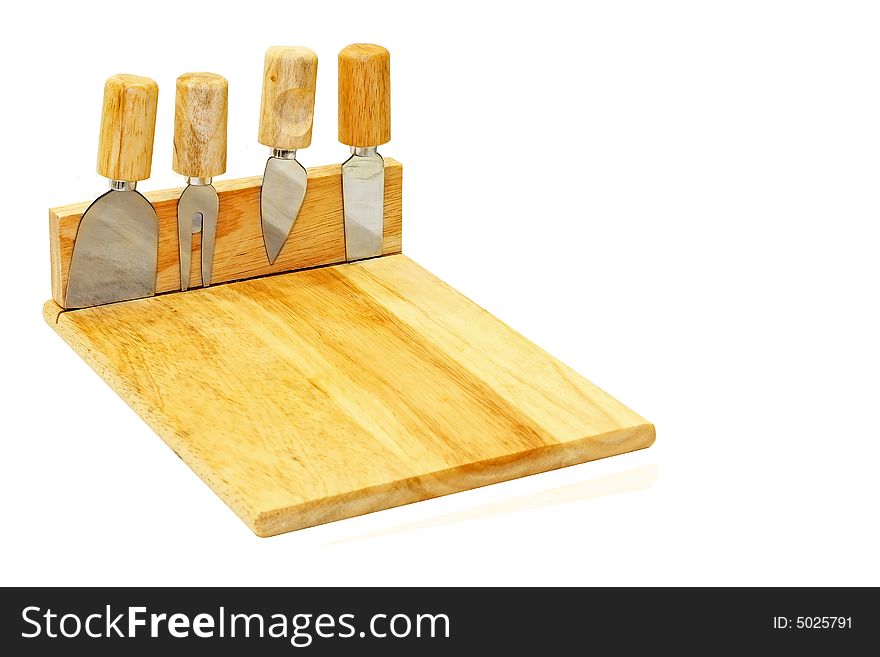 Wooden board and four cheese knifes isolated