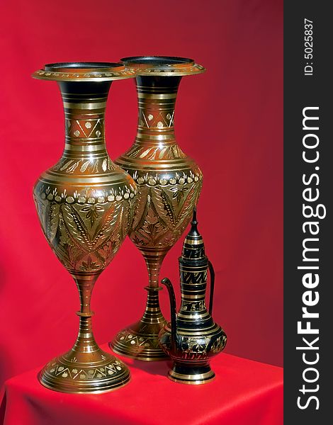 Beautifully handcrafted vases from India with a red background. Beautifully handcrafted vases from India with a red background.