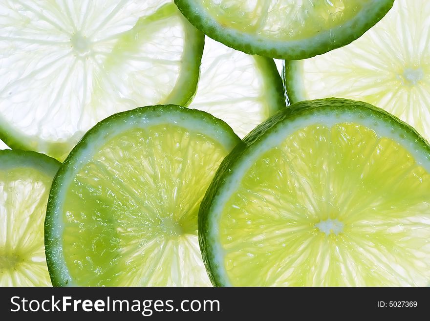 Slices of green lime on the white. Slices of green lime on the white