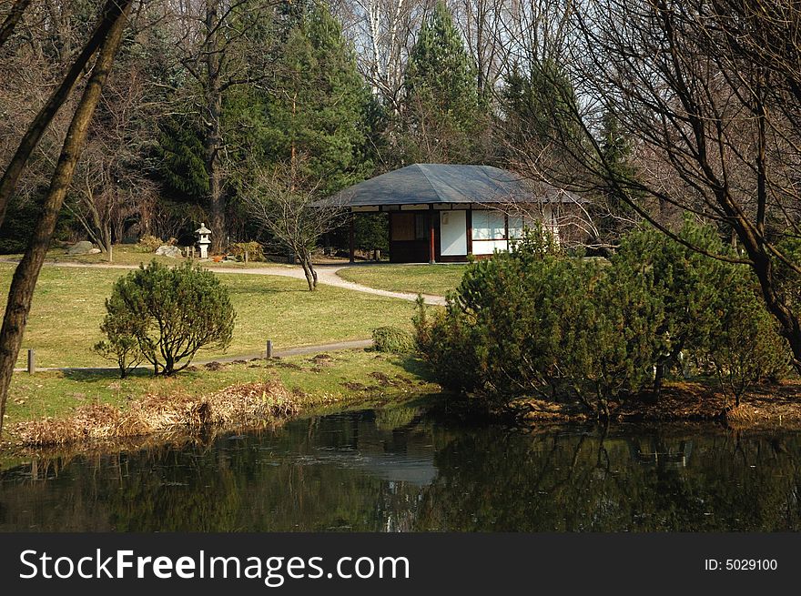 Japanese garden with tea room and a pond in early spring