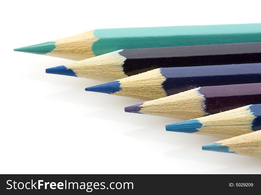 Variously tinted blue pencils on a white background. Variously tinted blue pencils on a white background