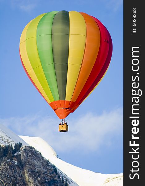 Colorful hot air balloon glides in the blue sky. Colorful hot air balloon glides in the blue sky