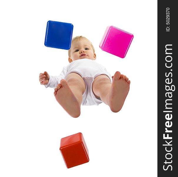 A little boy standing over blocks and looking at camera. Isolated on white background. Unusual angle view - directly below. A little boy standing over blocks and looking at camera. Isolated on white background. Unusual angle view - directly below.