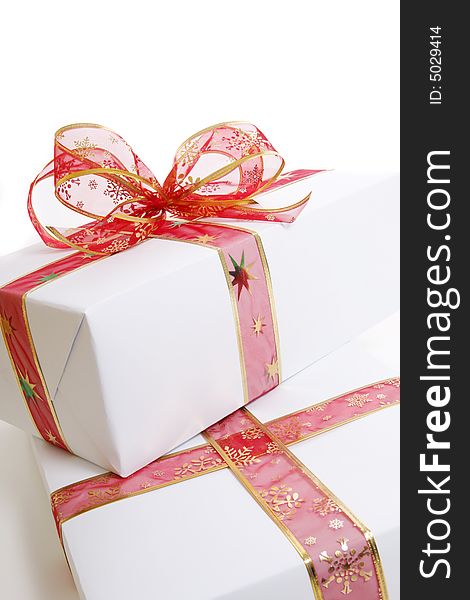 White box wrapped in red bow and ribbon. White box wrapped in red bow and ribbon