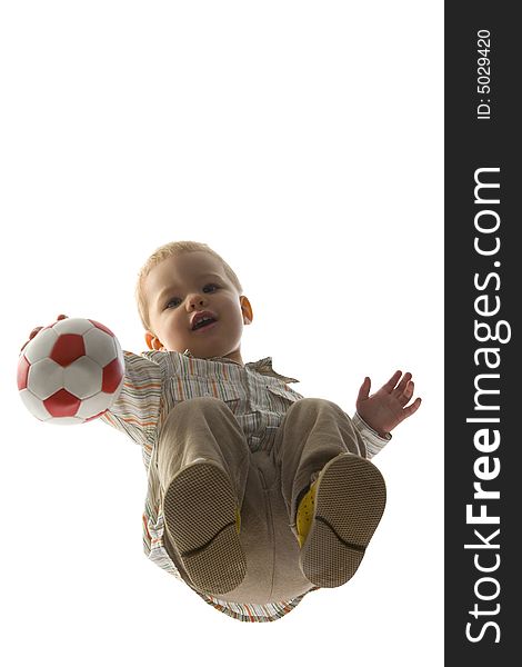 Baby boy squatting and holding ball. Looking at camera. Isolated on white background. Unusual angle view - directly below. Baby boy squatting and holding ball. Looking at camera. Isolated on white background. Unusual angle view - directly below.
