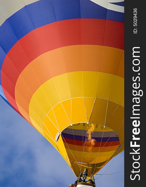 Colorful hot air balloon glides in the blue sky. Colorful hot air balloon glides in the blue sky