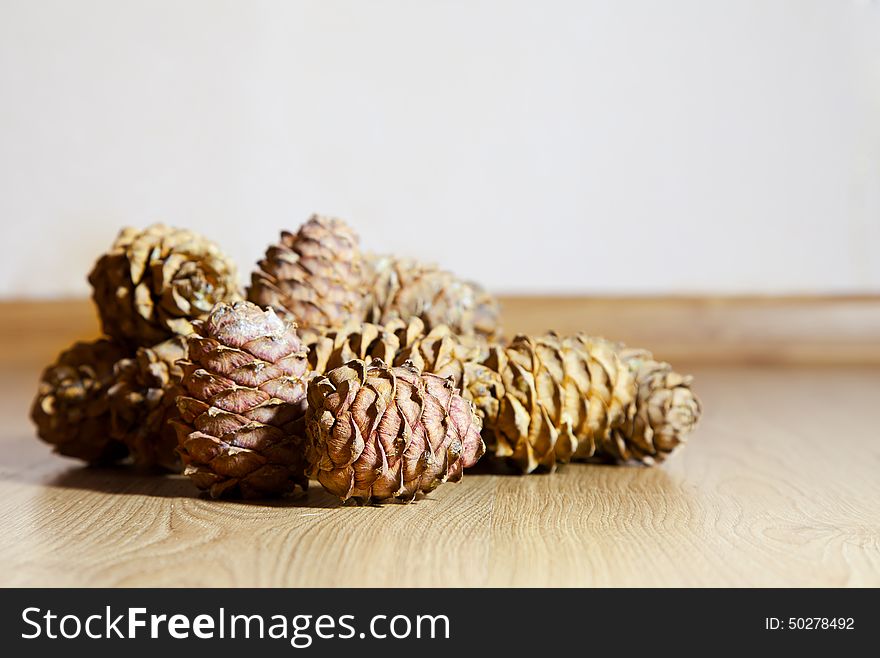 Cedar cones lying on wooden floor. Cedar cones lying on wooden floor