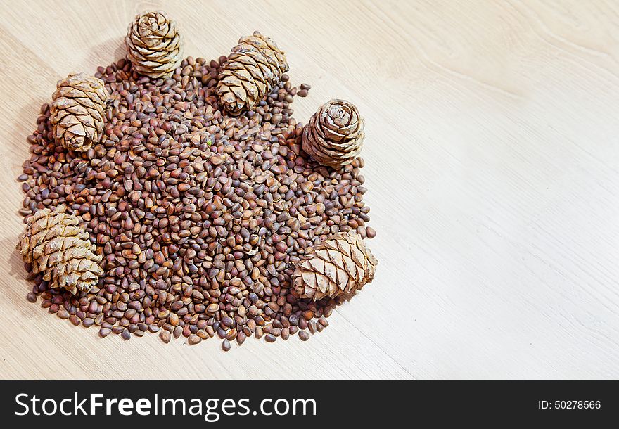 Cedar nuts and cones om wooden floor