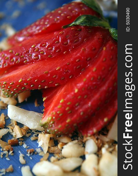 Close-up/macro of strawberry and nuts on a blue plate