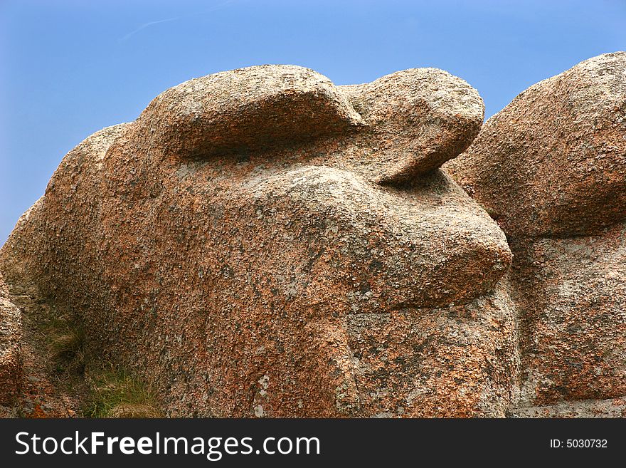 Rock formation on the Pink Granite Coast in Brittany, France in the shape of a head. Rock formation on the Pink Granite Coast in Brittany, France in the shape of a head