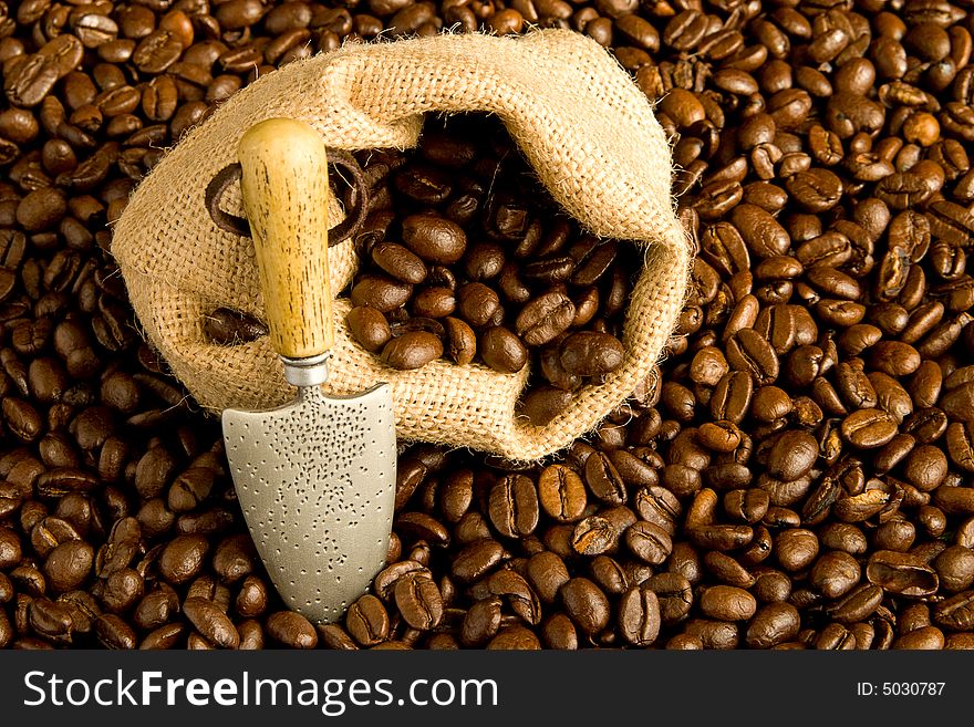 Coffee bag with spade among the coffee beans