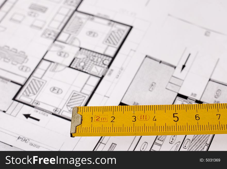 Architecture planning of interiors designed on paper, focus on wooden metre. Architecture planning of interiors designed on paper, focus on wooden metre