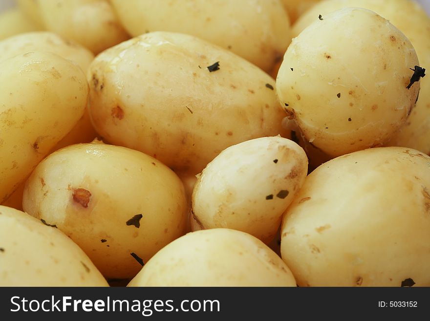 Freshly dug new potatoes covered in melted butter