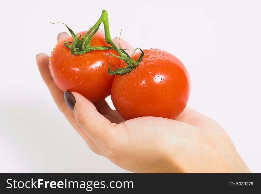 Female hand and two fresh tomatoes. Female hand and two fresh tomatoes